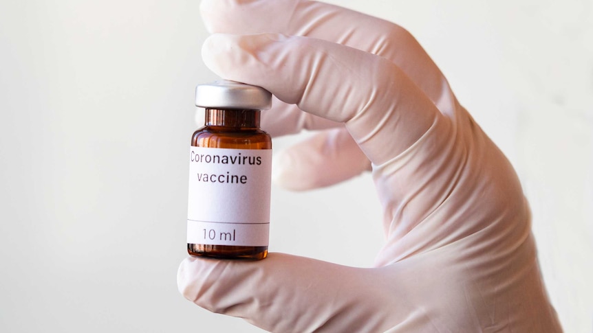 Someone holding a Coronavirus vaccine vial