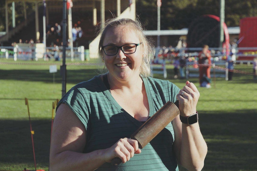 woman smiling and holding rolling pin
