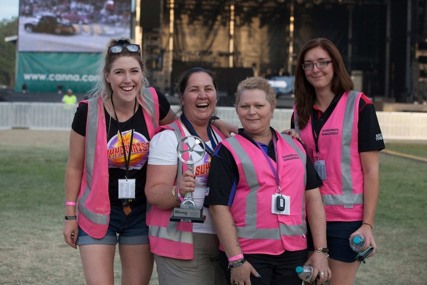 Four women from the Summernats team pose at the EPIC showgrounds in Canberra during the 2017 festival.