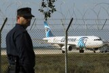 A policeman stands guard at Larnaca Airport near a hijacked Egyptair A320.