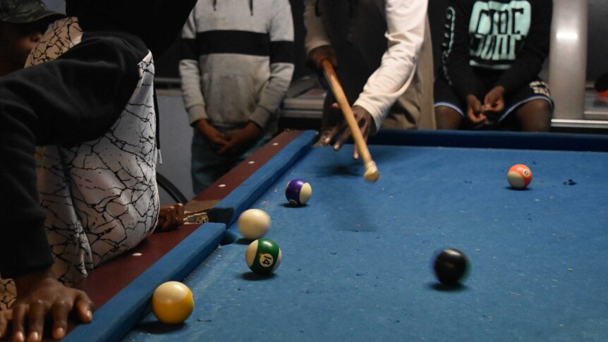 Kids play pool at the youth centre in Alice Springs