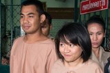 Thai students Patiwat Saraiyaem and Porntip Mankong leave Bangkok's criminal court