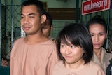 Thai students Patiwat Saraiyaem and Porntip Mankong leave Bangkok's criminal court