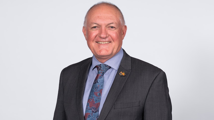 Indigenous Affairs minister David Harris wearing a dark suit and blue shirt