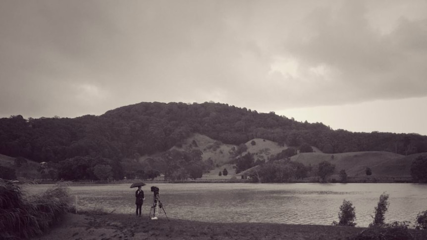 Journalist Jade Macmillan reporting from Tweed River at Tumbulgum.