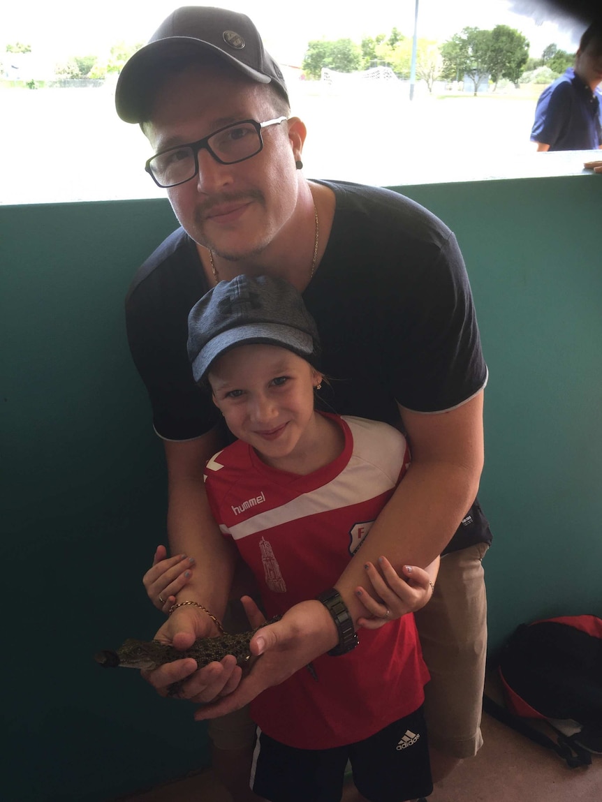 Wesley de Kruijf and his daughter Elijza holding the baby crocodile.