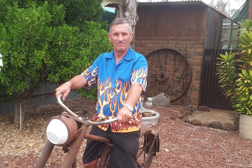 A man sitting on a bicycle.