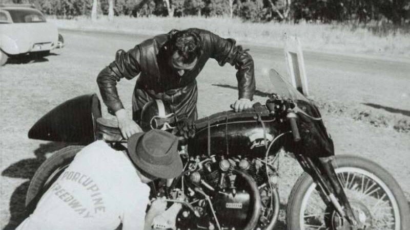 Motorcyclist Jack Ehret attending to technical problems on his Vincent Black Lightning motorcycle.