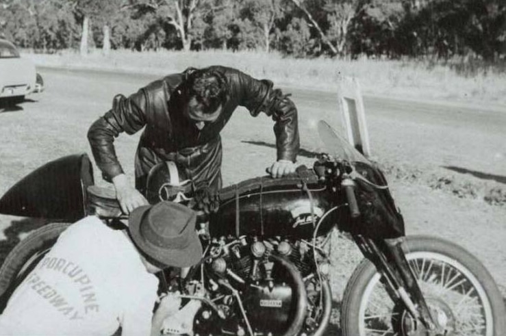 Motorcyclist Jack Ehret attending to technical problems on his Vincent Black Lightning motorcycle.