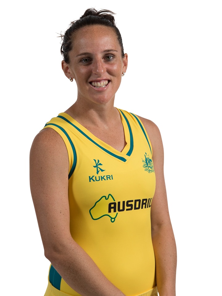 Woman in Australian gold hockey uniform