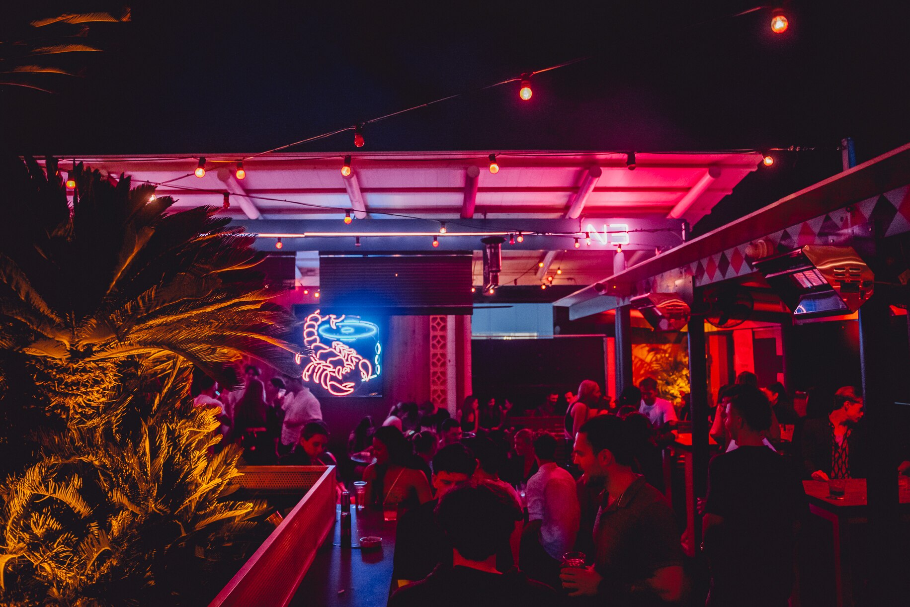 People at a dimly lit rooftop venue