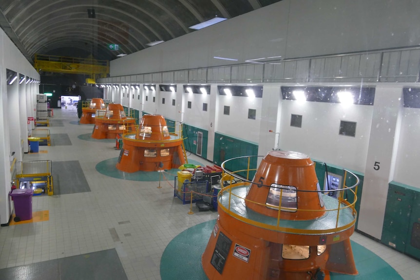 Large turbines inside a dam.