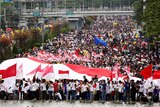 Thousands of people pack a main street in central Jakarta.