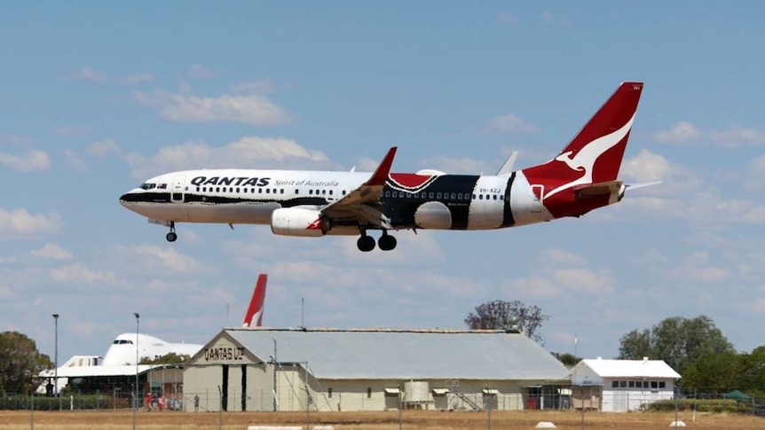 A Qantas plane flies over the Founders Museum in Longreach, Queensland
