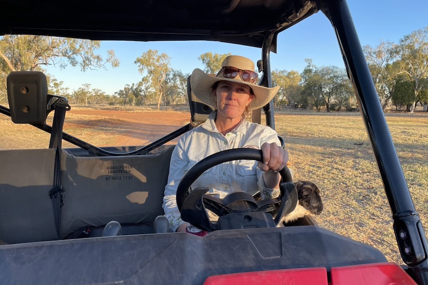 Jodie sits behind the wheel of a truck.