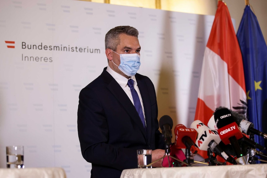 Austria's Interior Minister Karl Nehammer attends a news conference.