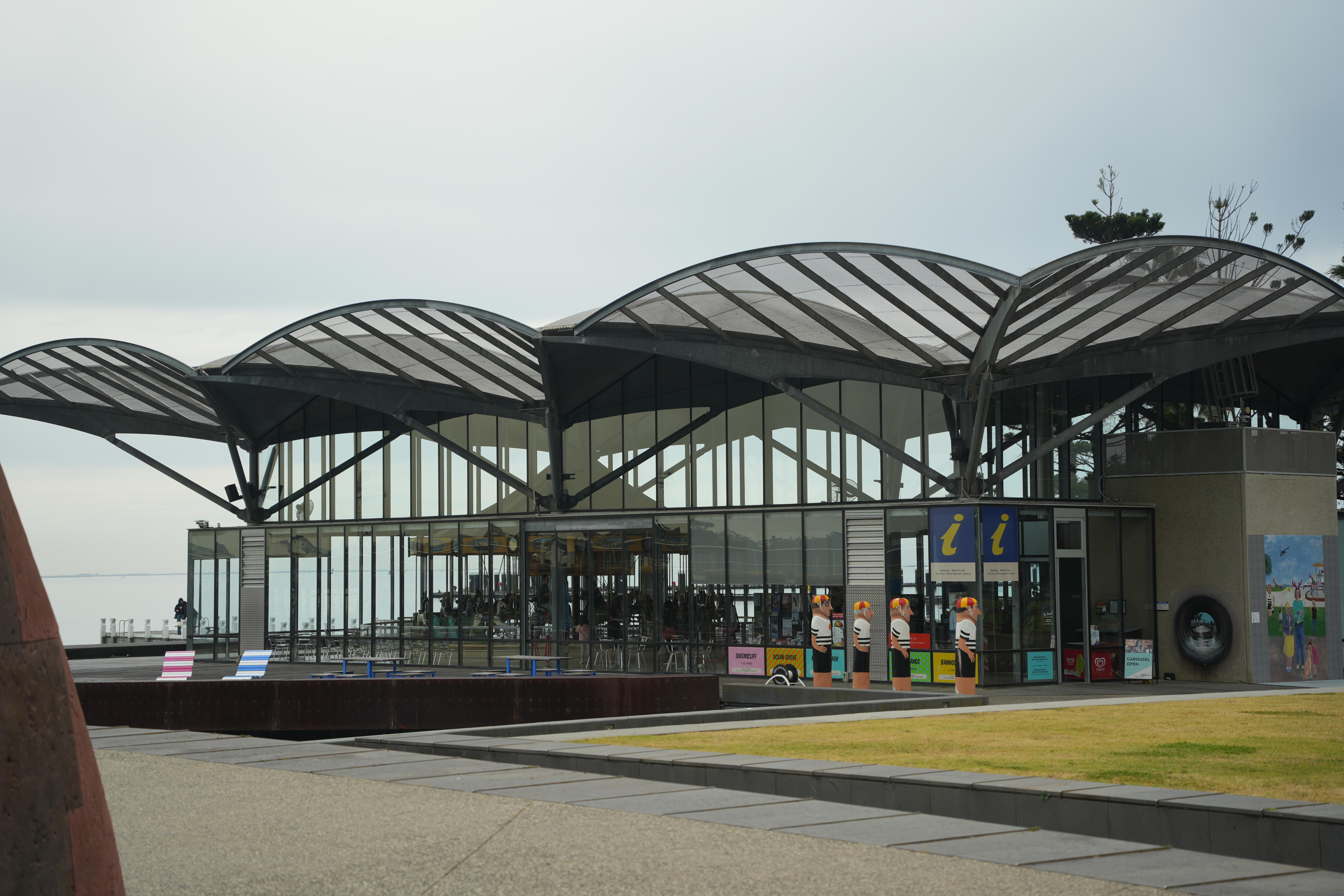A waterfront public building of glass with concentric arched glass-panelled roof.