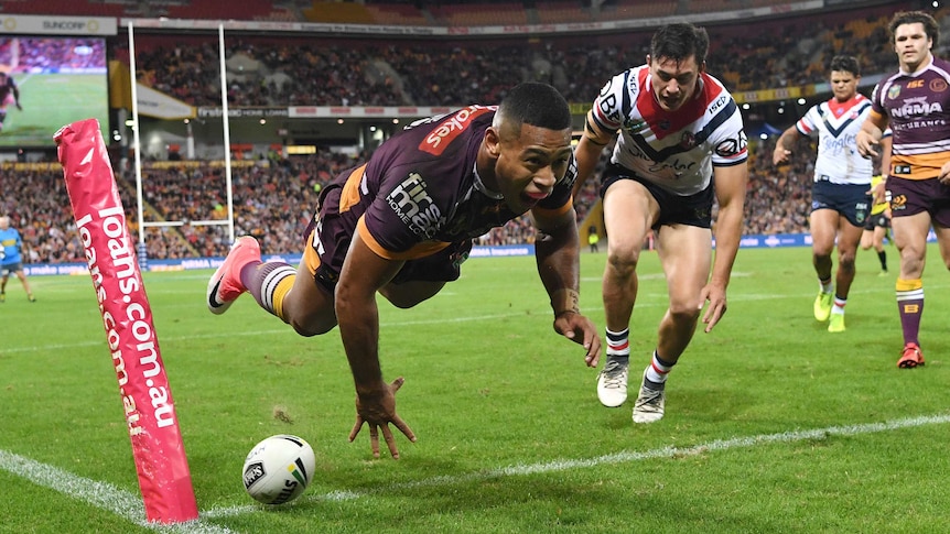 Jamayne Isaako is airborne after diving over to score a try for the Broncos against the Roosters.