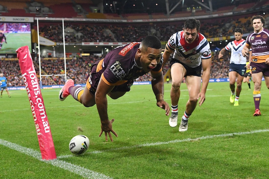 Jamayne Isaako is airborne after diving over to score a try for the Broncos against the Roosters.