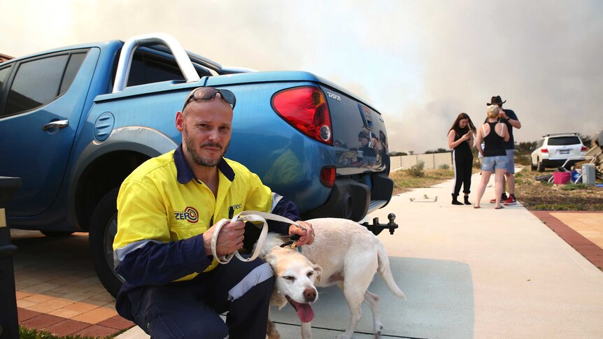 Yanchep resident Simon Evans prepares to leave with his family and dog Daisy.