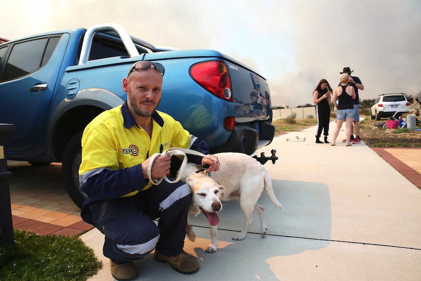 Yanchep resident Simon Evans prepares to leave with his family and dog Daisy.