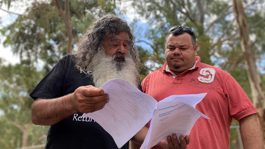 Kaurna elder Jeffrey Newchurch and Timothy Williams look over the Museum of South Australia's policy papers