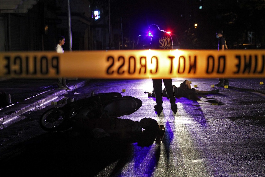 Two suspects lie dead on the street of Adriatico, Manila after failing to stop at a police checkpoint.