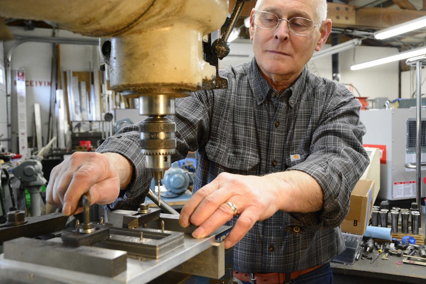 Larry Brester works on a part in his workshop.