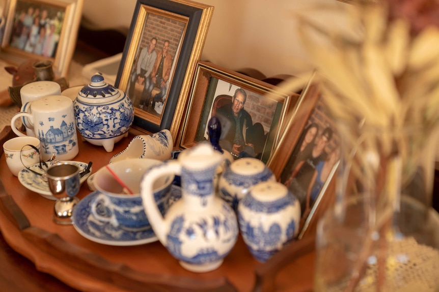 Pictures of Jo-an Engelbrecht's parents and family on a table inside his home.