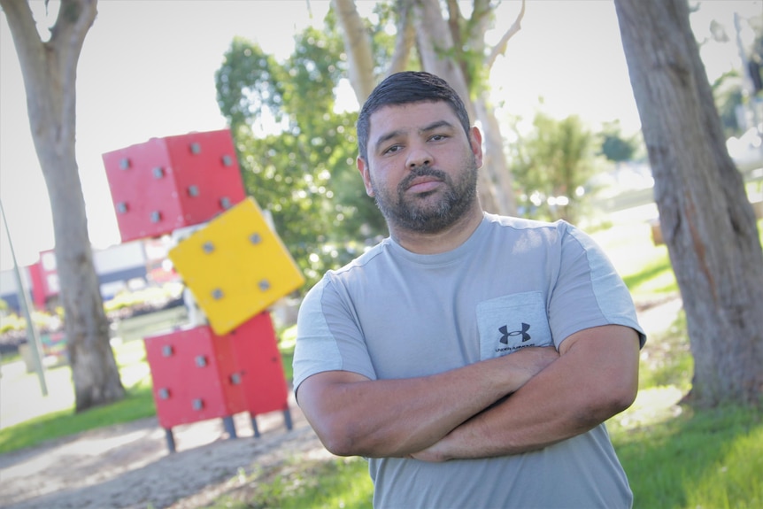 Micheal Morris stands with armed crossed in park at Logan, south of Brisbane.