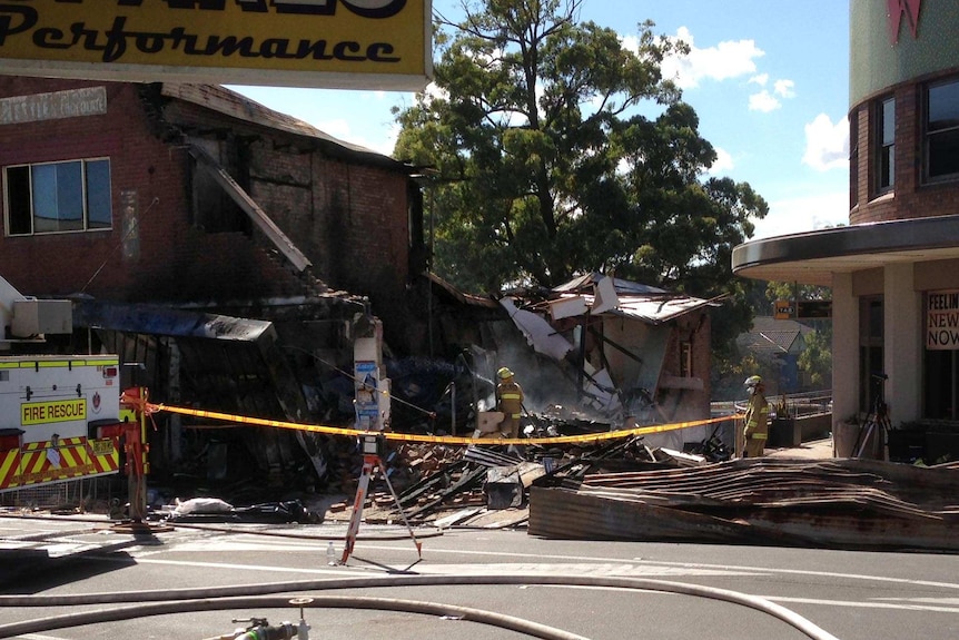 Fire crews work at the site of a discount supermarket following an explosion.
