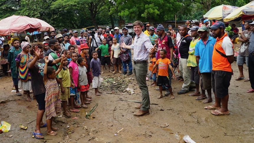 Eric Tlozek surrounded by PNG villagers.