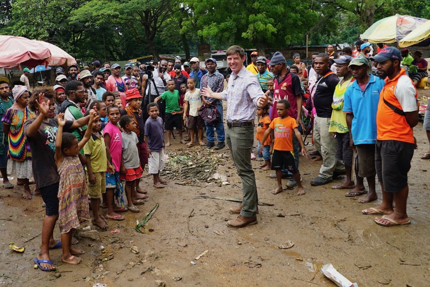 Eric Tlozek surrounded by PNG villagers.