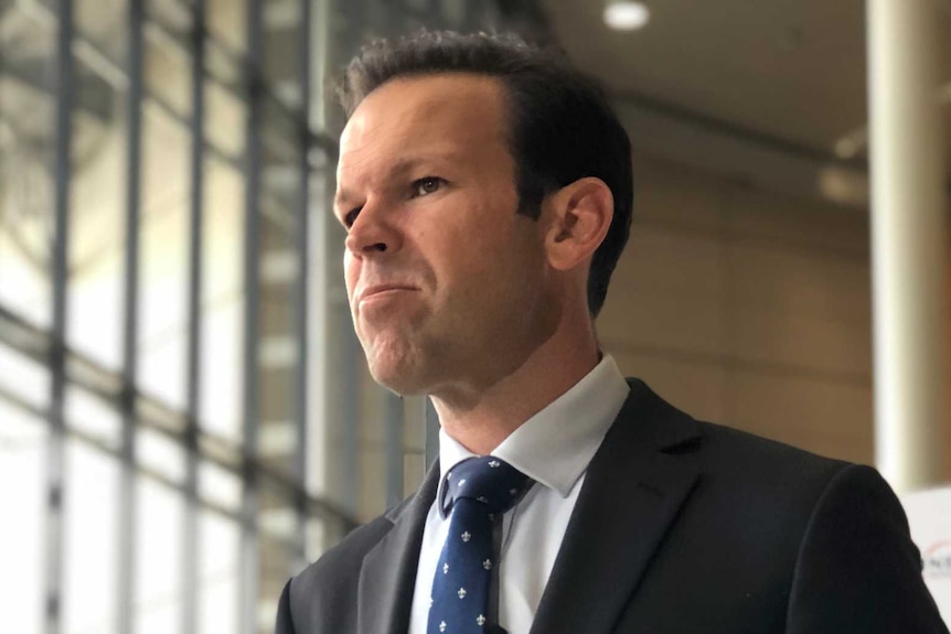 Federal Resources Minister Matt Canavan standing in front of TV mics.