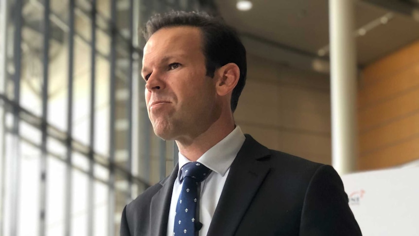 Federal Resources Minister Matt Canavan standing in front of TV mics.