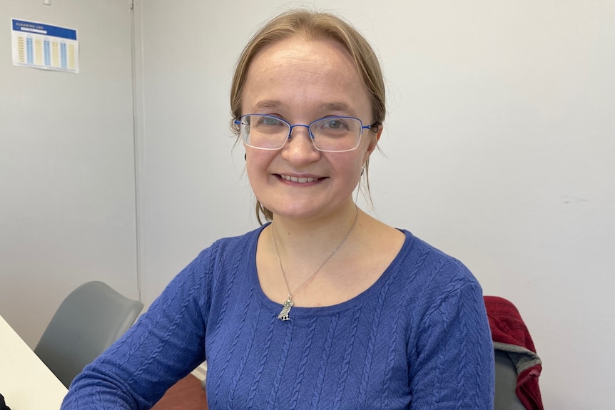 Mid portrait of business woman in a blue top smiling