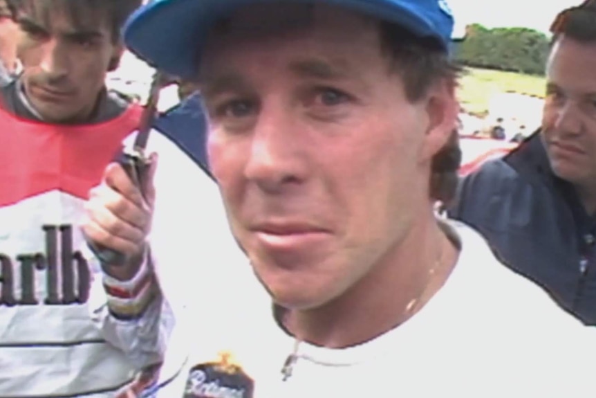 Close up of a man wearing a cap.
