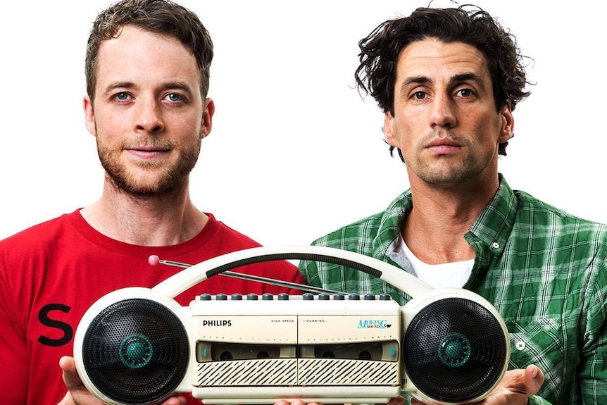 Radio announcers Hamish and Andy holding a vintage radio.