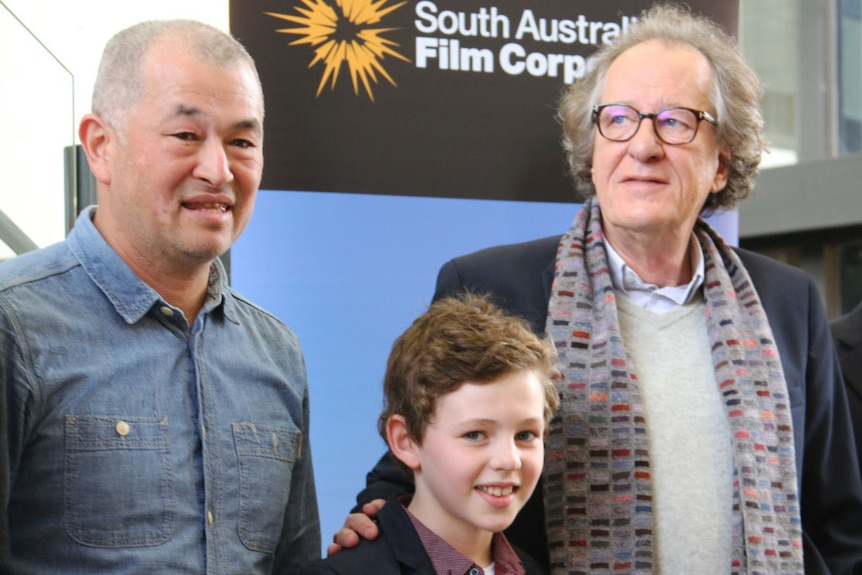 Director Shawn Seet on the left with actors Finn Little in the middle and Geoffrey Rush on right of picture.