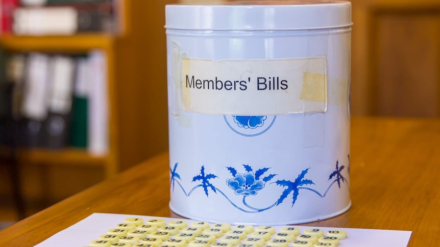 A biscuit tin containing New Zealand bill ballots sitting on a desk in NZ parliament