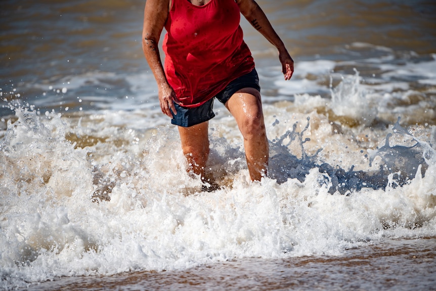 The lower half of Raelene's body, coming in from the beach.