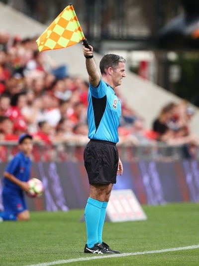A soccer assistant referee on the touchline.