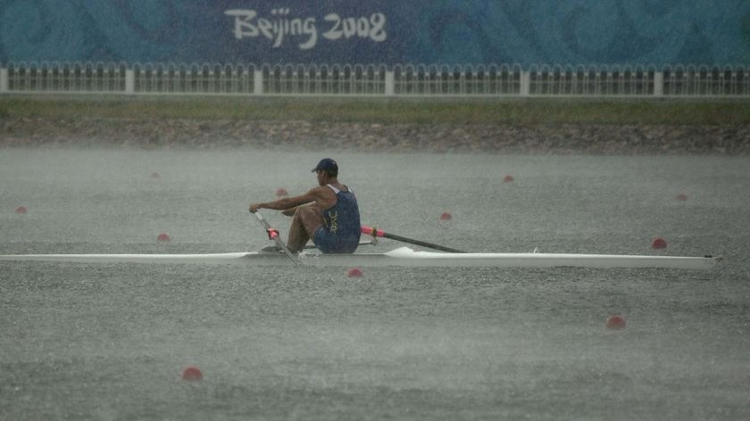 A rower practises in heavy rain