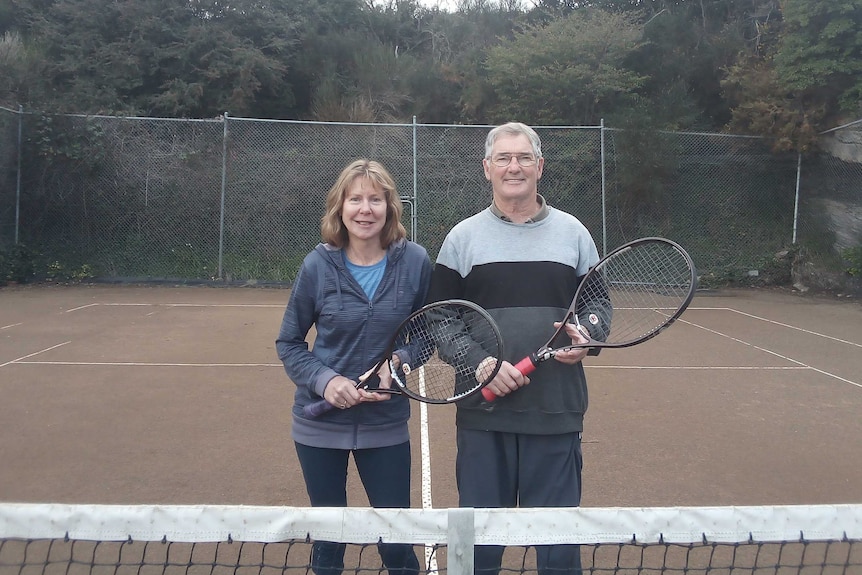 Claire and Jeff Irwin holding tennis rackets.