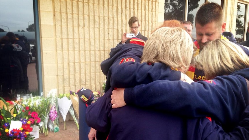 Crows fans comfort each other