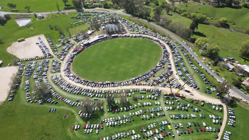 An aerial view of hundreds of cars parked at Sandy Creek Recreation Reserve