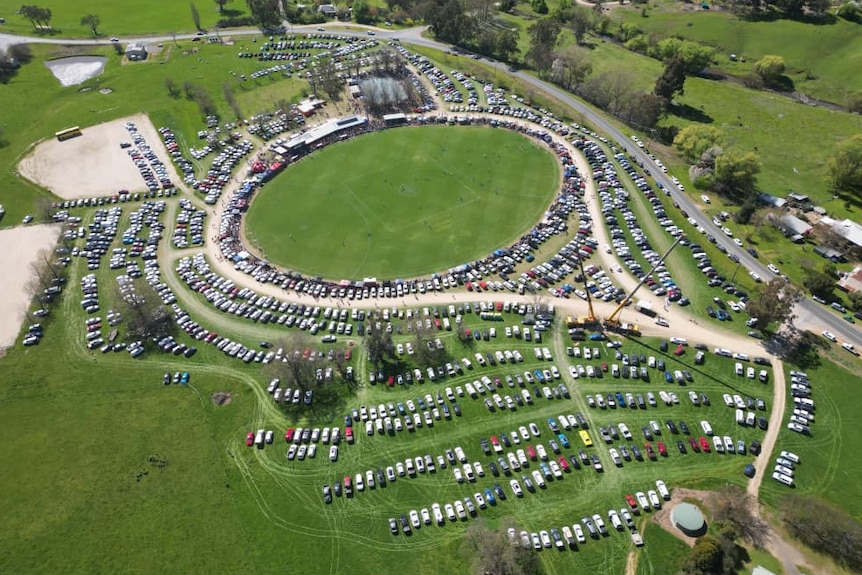 An aerial view of hundreds of cars parked at Sandy Creek Recreation Reserve