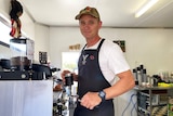 Tim Thomas makes coffee for a customer  in his drive-through coffee shop at Eagle Farm in Brisbane.