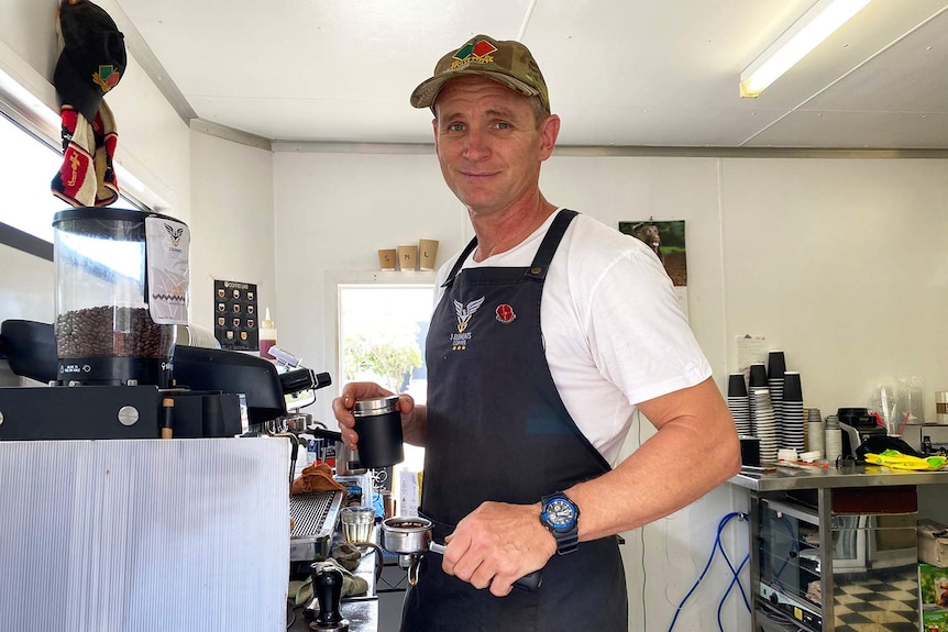 Tim Thomas makes coffee for a customer  in his drive-through coffee shop at Eagle Farm in Brisbane.