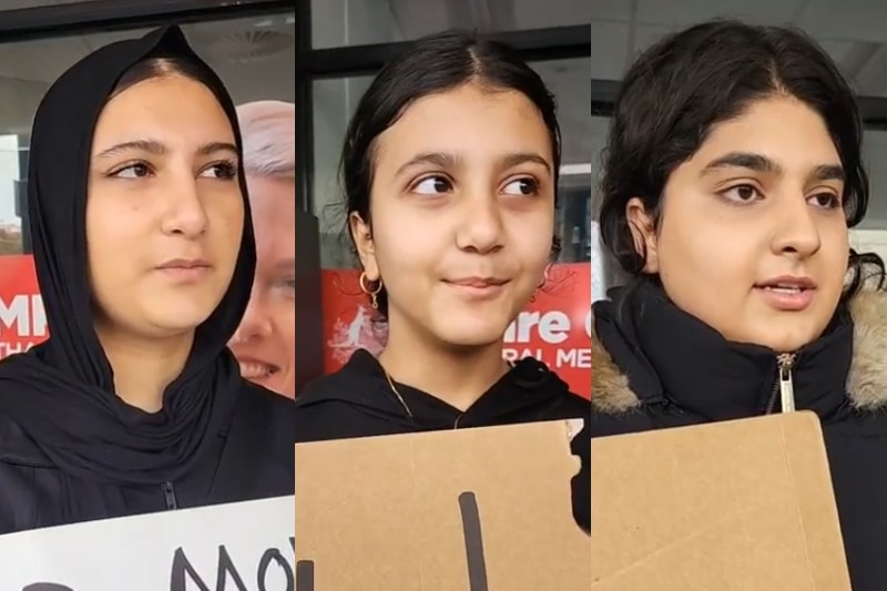 Three young women with an Iranian background speak to the camera at an migration law rally. 
